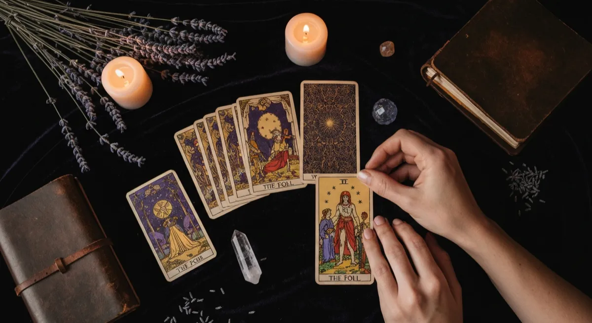 Tarot cards spread on dark velvet cloth with candlelight